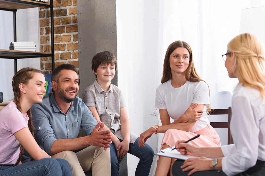 Family discussing with a therapist in office.