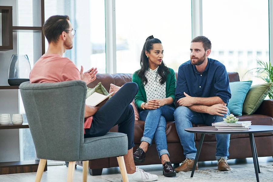 Couple in therapy session with counselor.