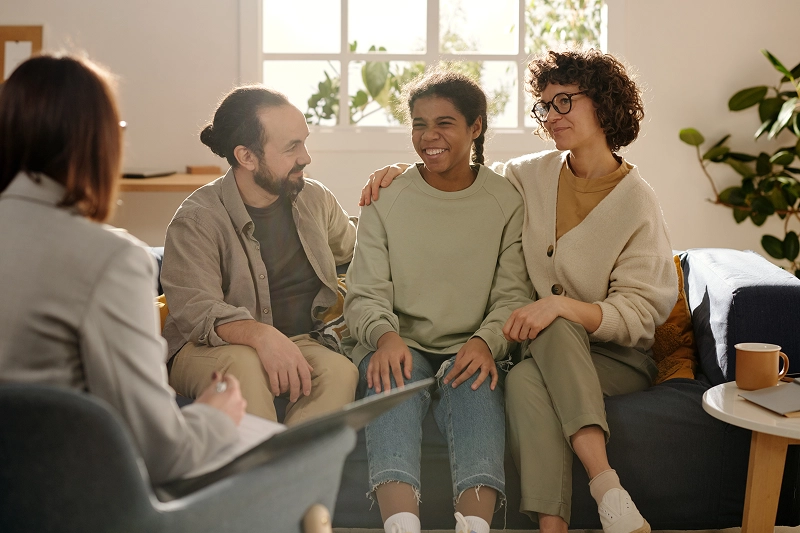 Family talking with a therapist in office.