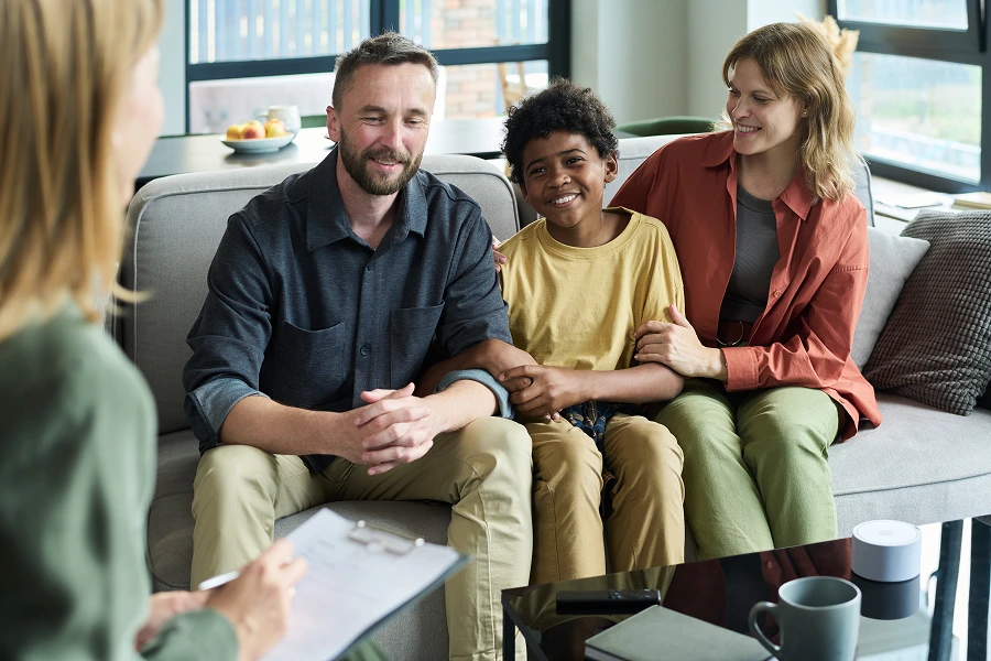 Family smiling during a counseling session.