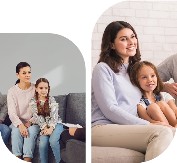 Two families sitting and smiling together.